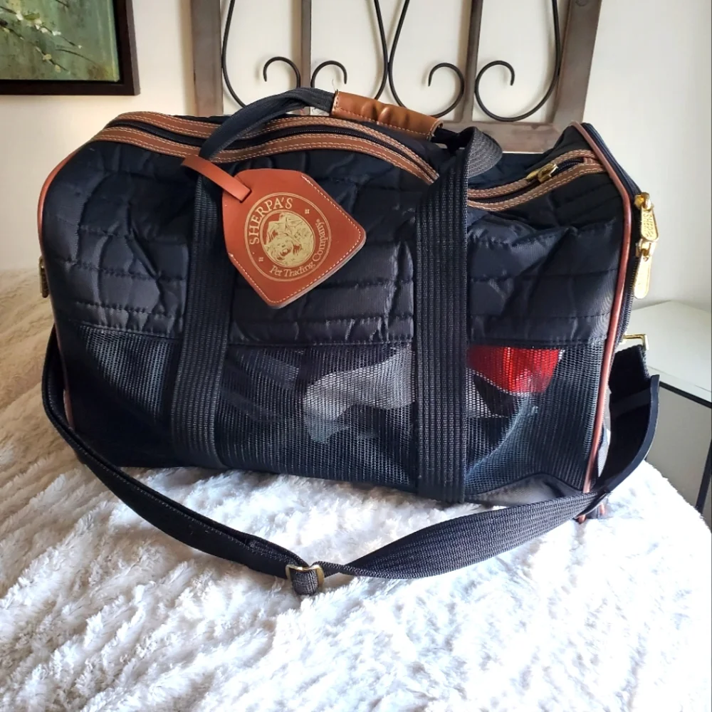 SHERPA'S mid size pet carrier with handles and shoulder strap.
